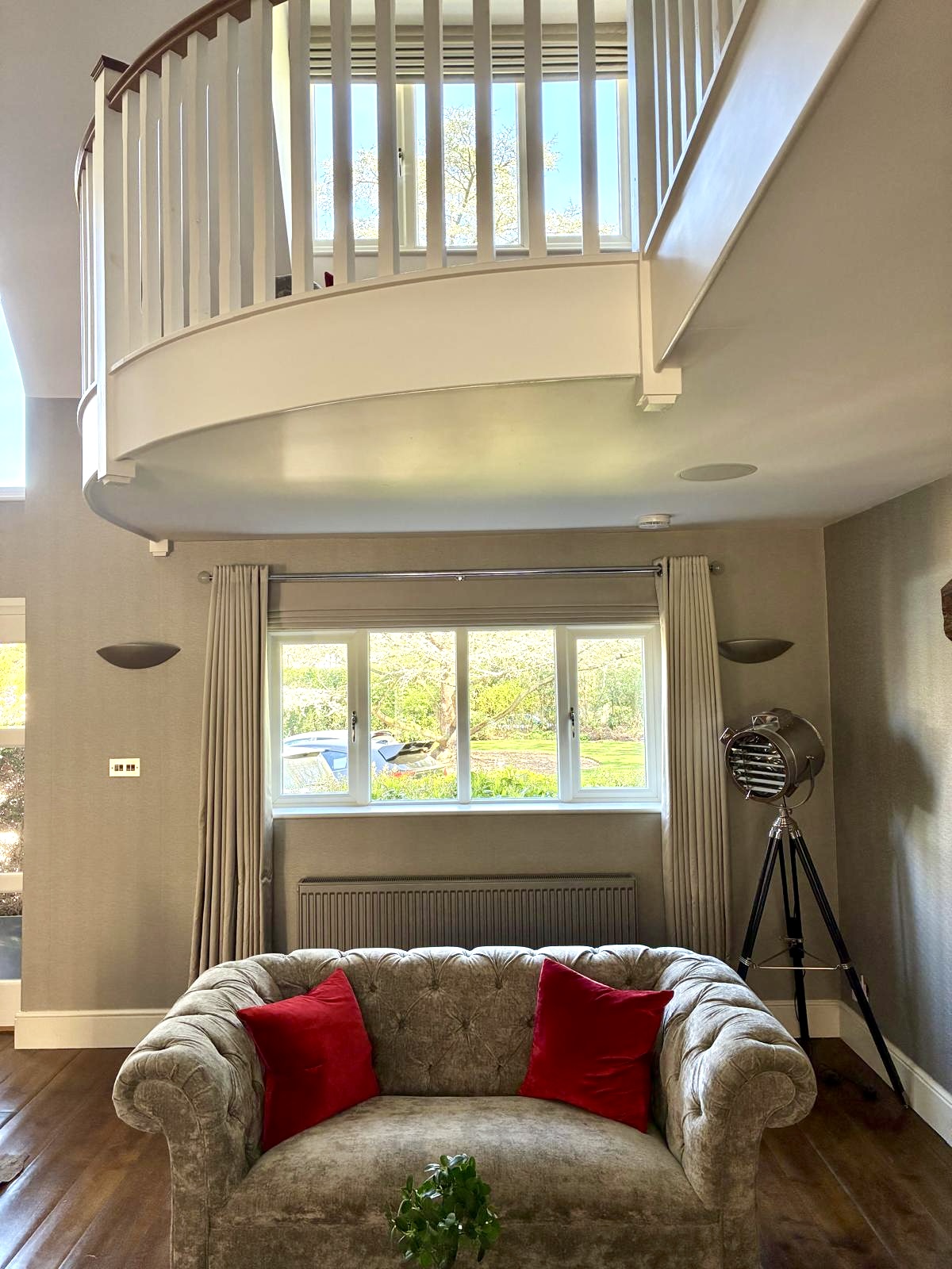 Tailored curtains and Roman blind in a double-height living room